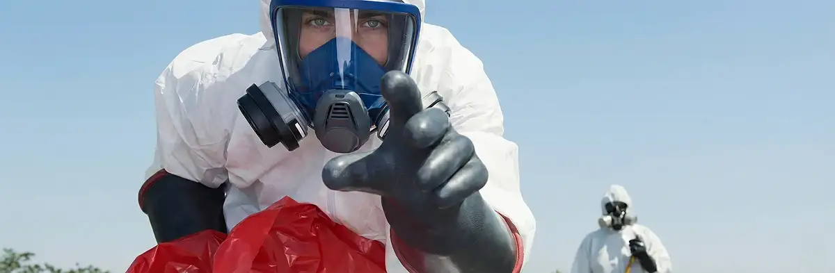 sewage clean up technician wearing protective gear handling biohazard materials in Tucson, AZ