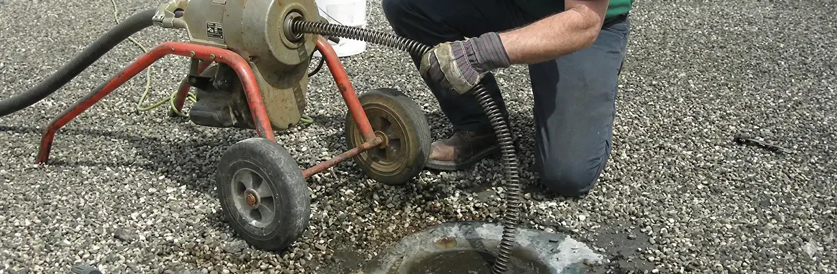 sewer rodding technician actively removing blockages from a sewer line in Tucson, AZ