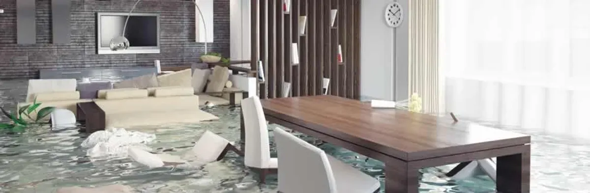 home interior affected by water damage with flooded floors and displaced furniture in Tucson, AZ